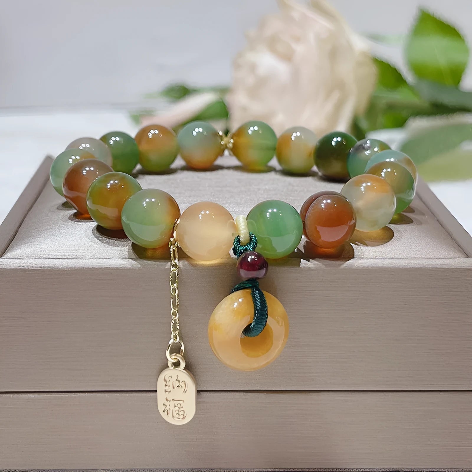 Yellow women's folk bracelet with peacock agate and topaz stones and a peace buckle clasp.