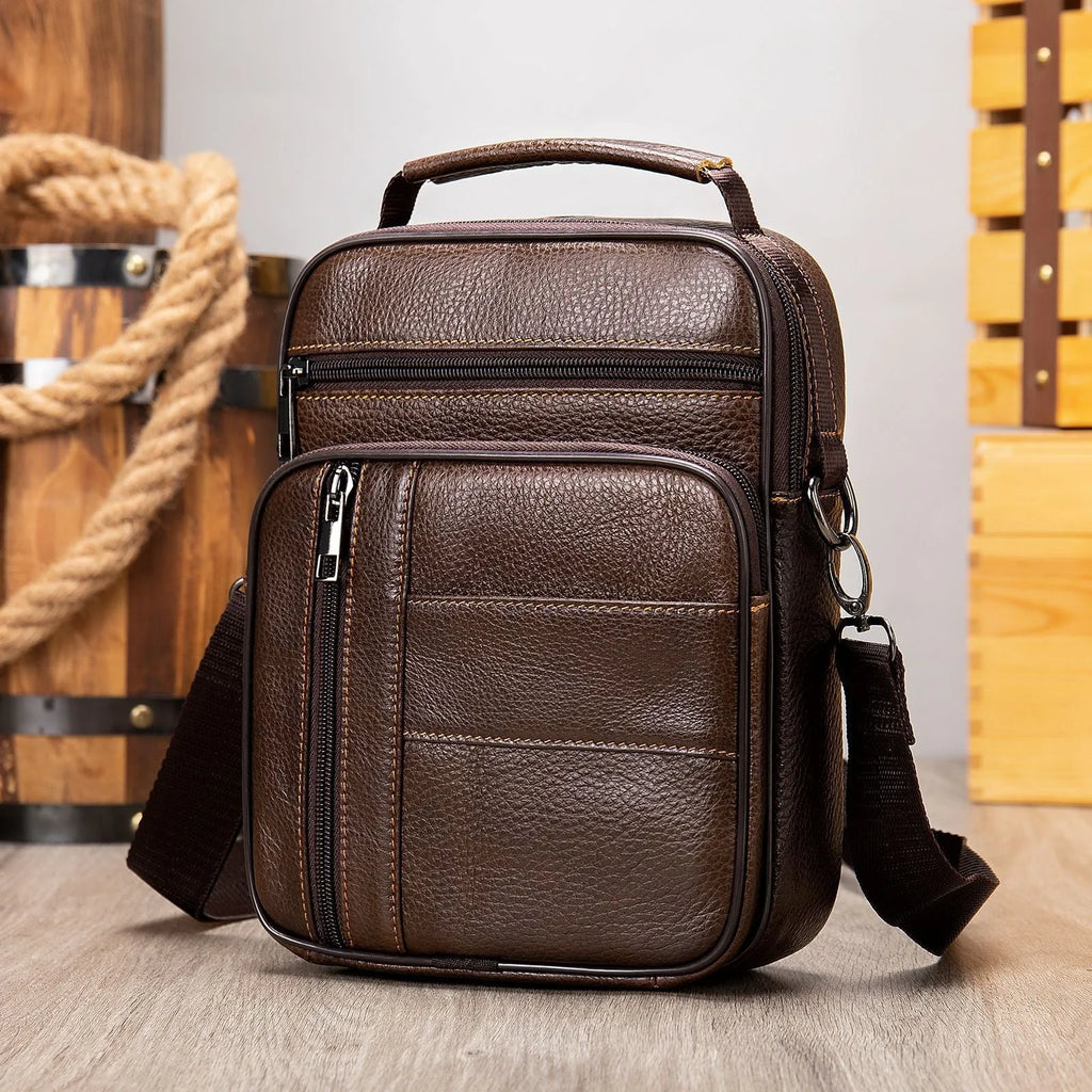 Men's vintage brown genuine leather shoulder bag showing vertical square shape and front zipper.