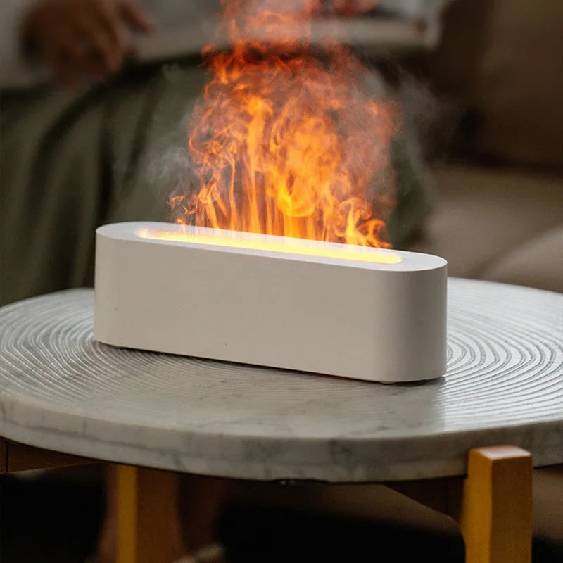 White square ultrasonic flame aroma diffuser with LED lights on a wooden table.