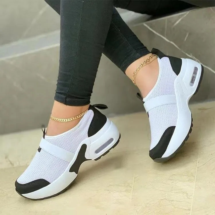 Women's flat lightweight sneakers in multiple colours with mesh upper and rubber sole.