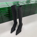 Black women's ankle boots with a pointed toe, stiletto heel, and a back zip fastening.