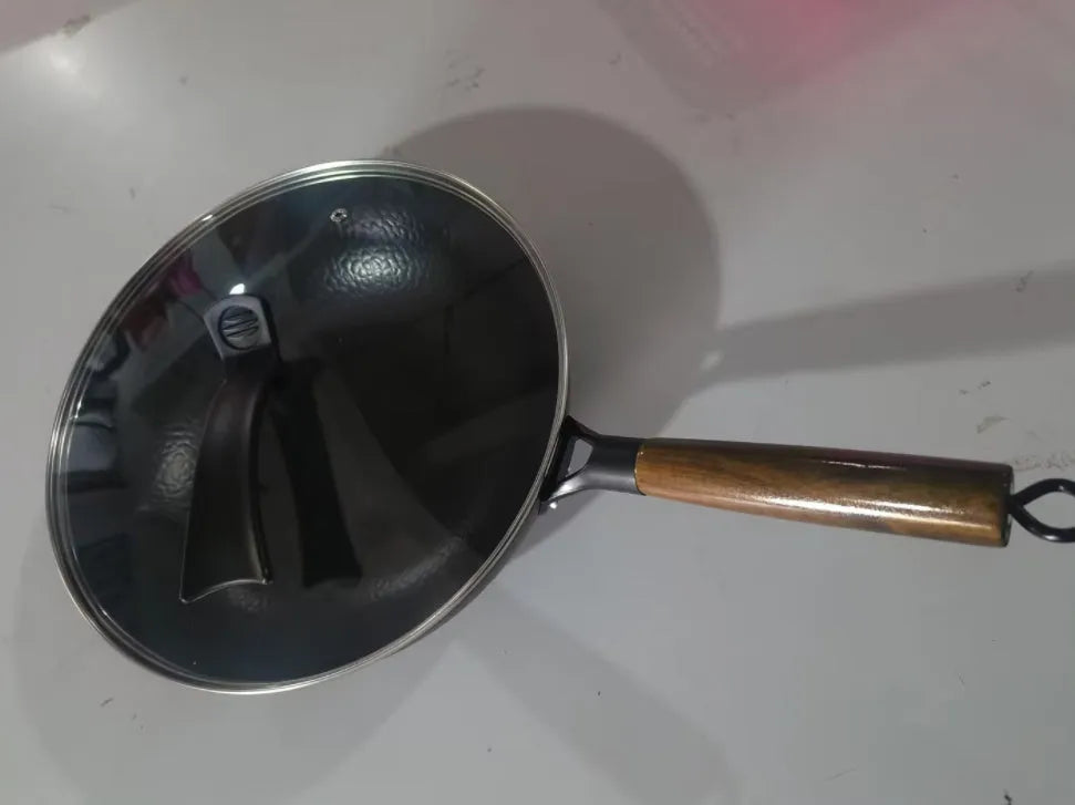 Traditional black iron wok pan with wooden handle measuring 40x32x10cm