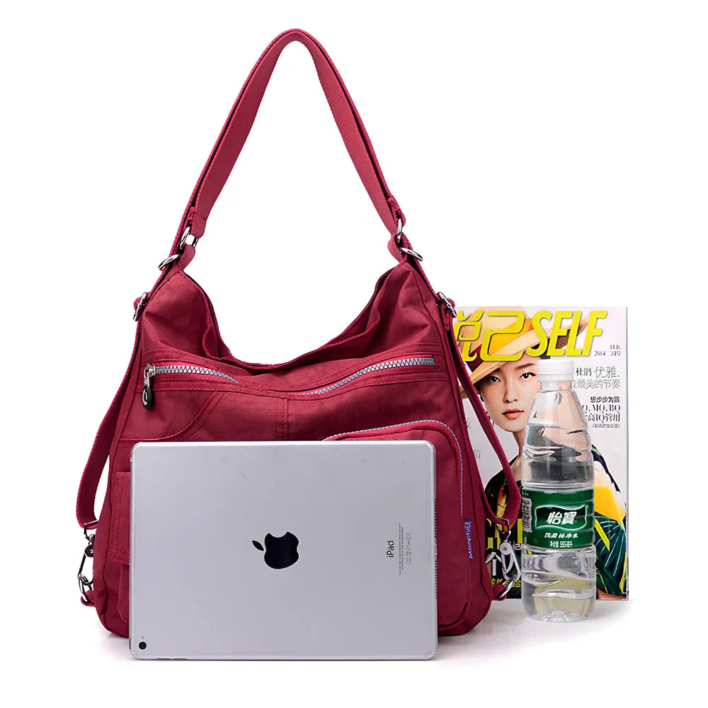 Women's waterproof nylon crossbody bag with organizational pockets and 34cm laptop capacity