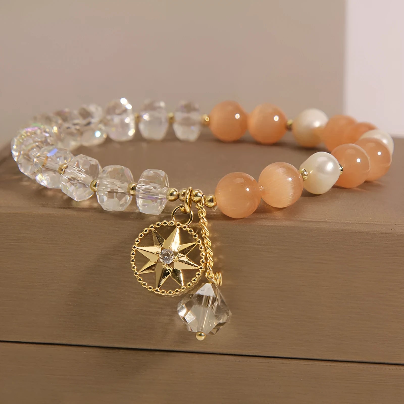 Orange eight Awn star bracelet with gold-plated inlaid gemstones showing detailed design