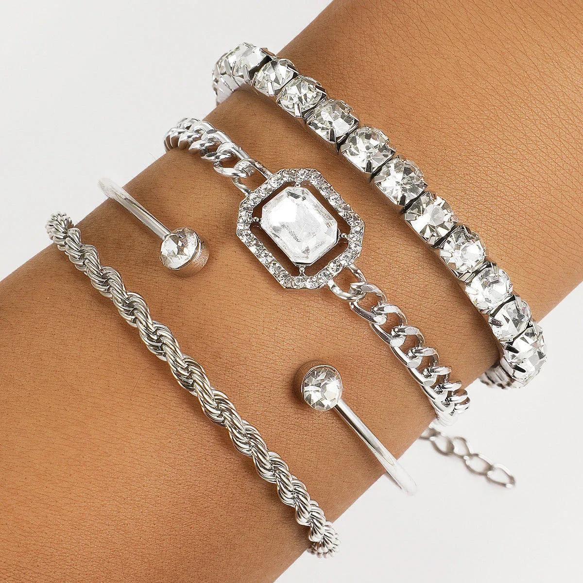 Premium 4-piece crystal bracelet set with adjustable fit and sparkling rhinestone embellishments, perfect for adding a touch of glamour to any outfit.