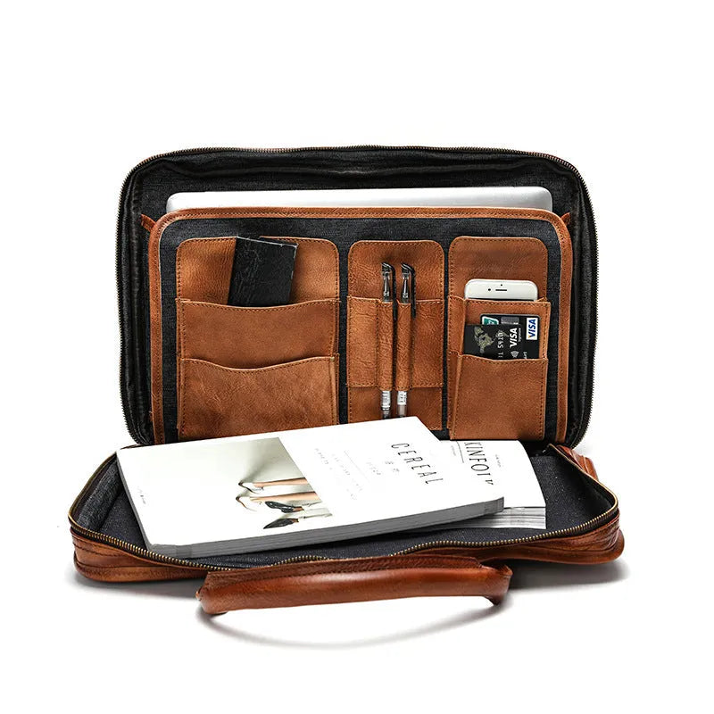 Vintage brown leather men's briefcase showing internal laptop and camera compartments.