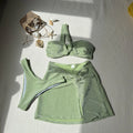 Women's one-shoulder tube top swimsuit three piece set in glossy polyester fabric, shown in light green.