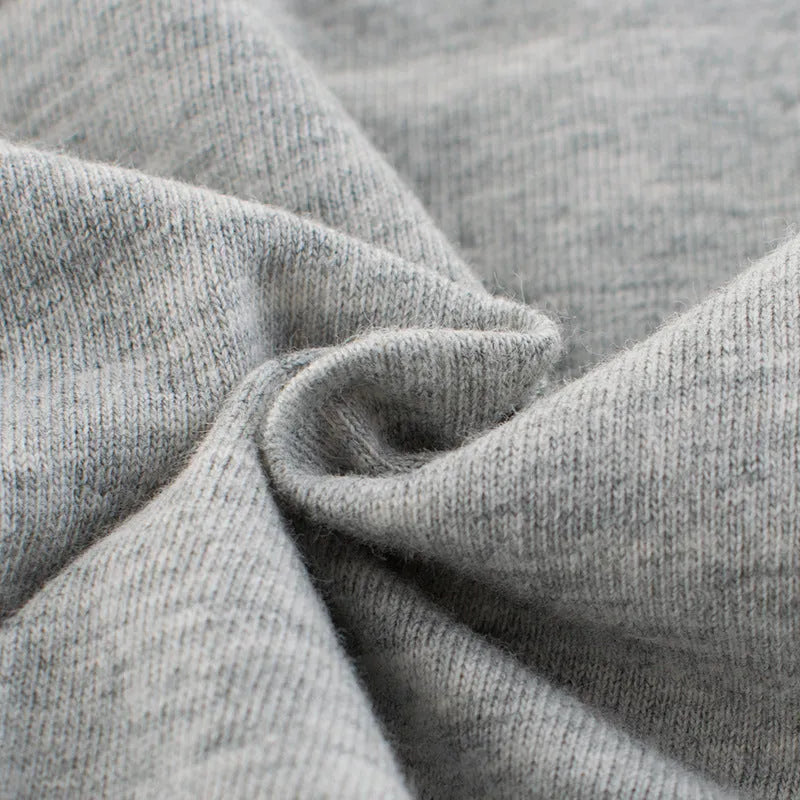 Grey cotton children's T-shirt laid flat, showing plain front and detailed size label.