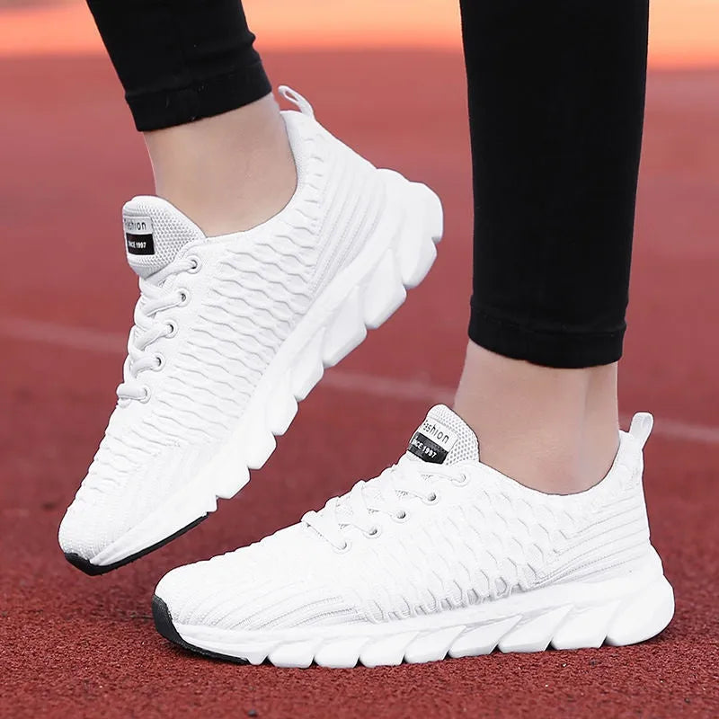 Women's running shoes in black with a fly weave upper and durable outsole.
