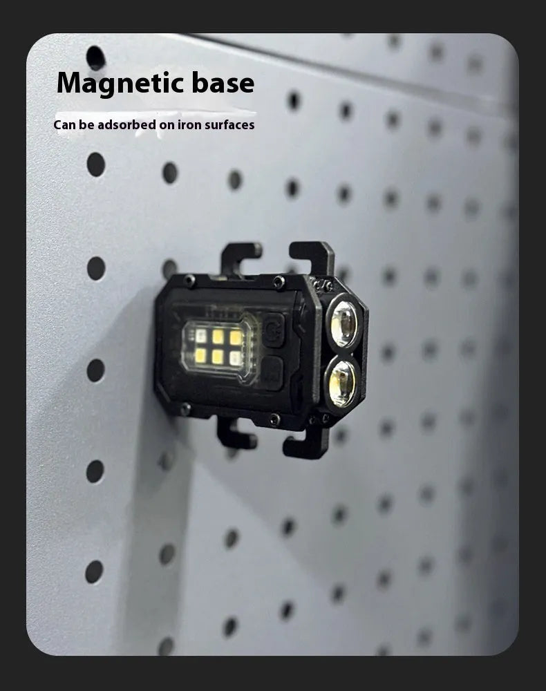 Black portable tactical mini warning flashlight with USB charging cable on a backpack strap.