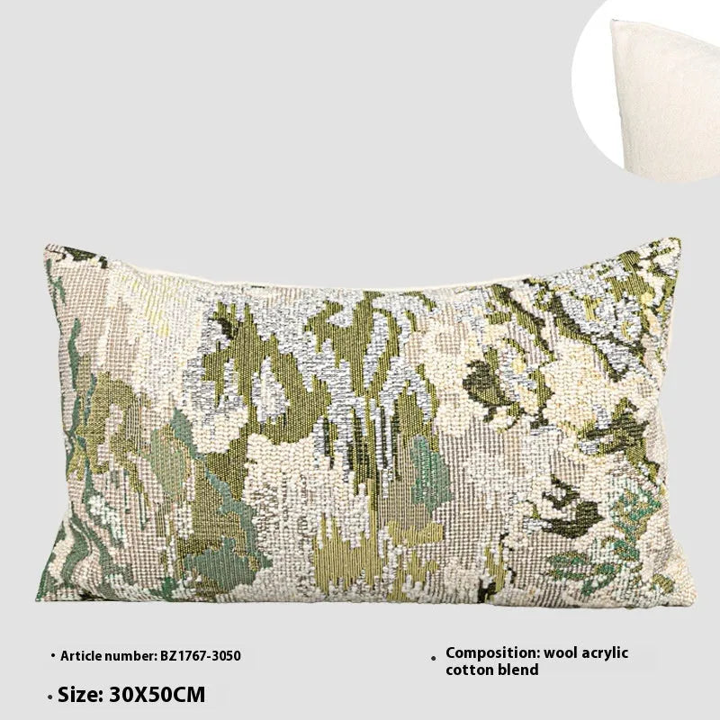 Green antique French style floral pattern wool blend decorative pillow on a sofa.