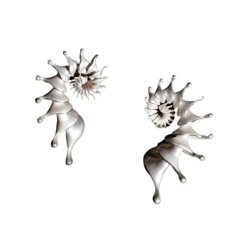 A pair of matte finish conch stud earrings with a three-dimensional, irregular alloy design.