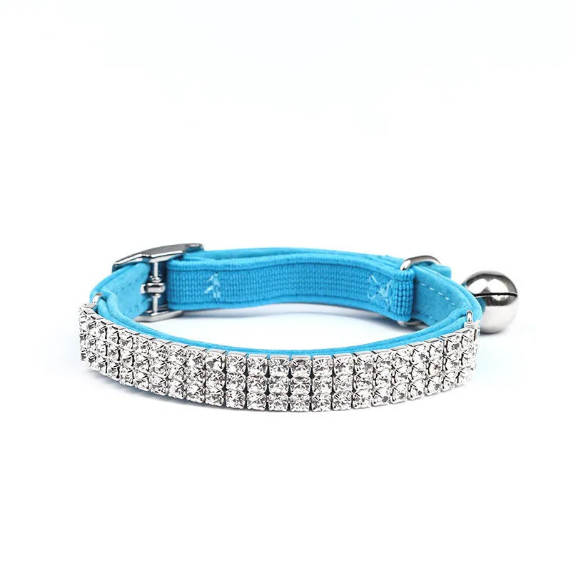 Adjustable velvet cat collar with rhinestone decoration in red, shown on a white background.