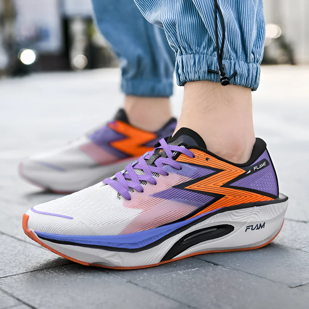 White and orange low-top running shoes with fabric upper, mesh lining, and a visible carbon plate design in the sole.