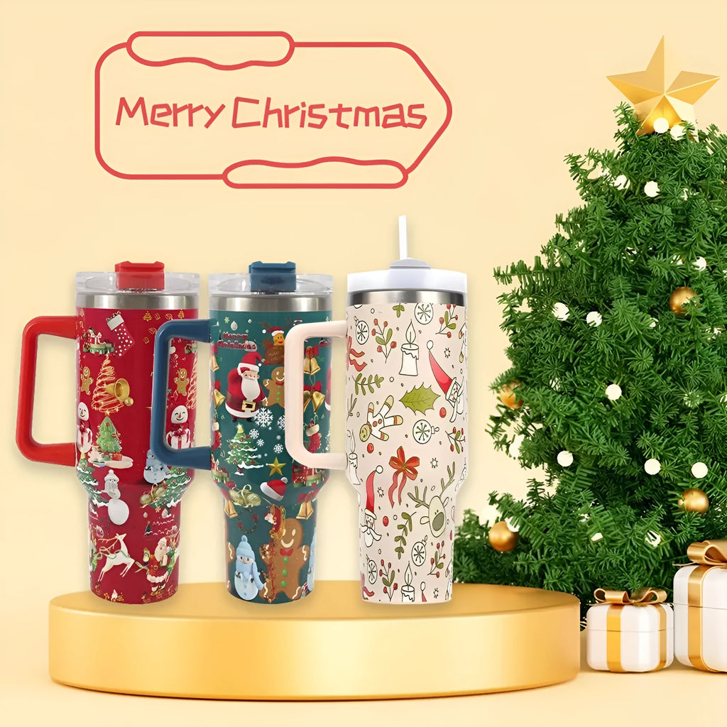 Red Christmas pattern stainless steel travel tumbler with handle, straw, and lid on a table.
