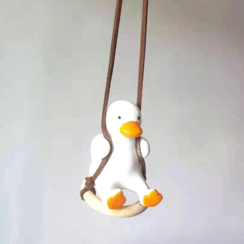 Swing Duck Car Pendant hanging from a rearview mirror, showcasing vibrant colors and unique design