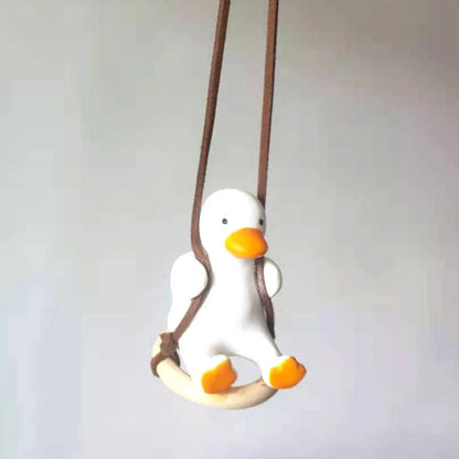 Swing Duck Car Pendant hanging from a rearview mirror, showcasing vibrant colors and unique design
