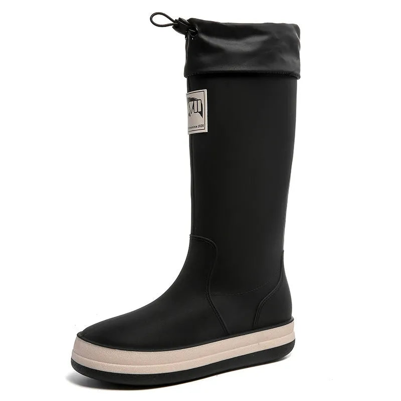 Pair of solid-colour high-tube PVC rain boots with a non-slip sole on a neutral background.