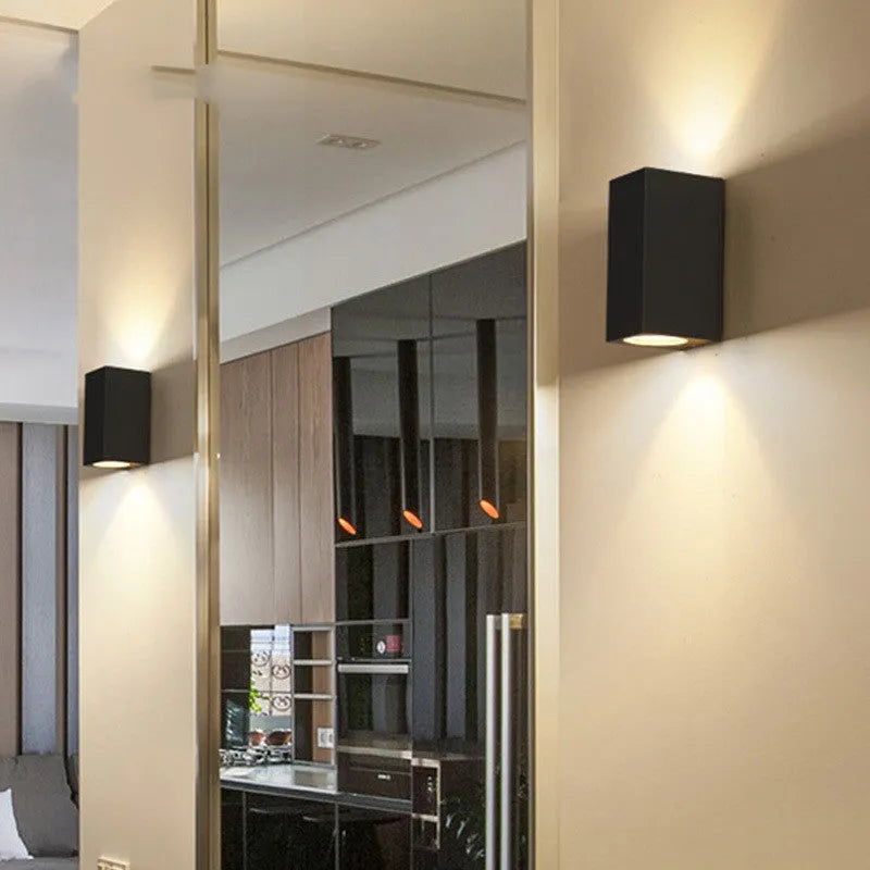 Modern black aluminium and glass wall lamp with silicone rubber detailing and integrated LED light.