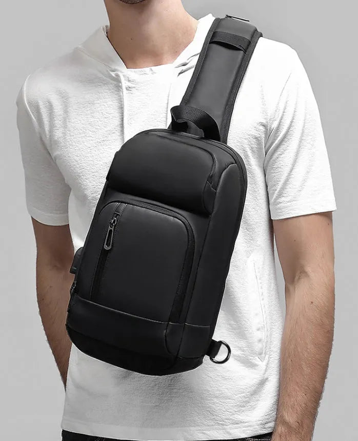 Black PVC outdoor shoulder bag with air cushion strap and internal organisation pockets