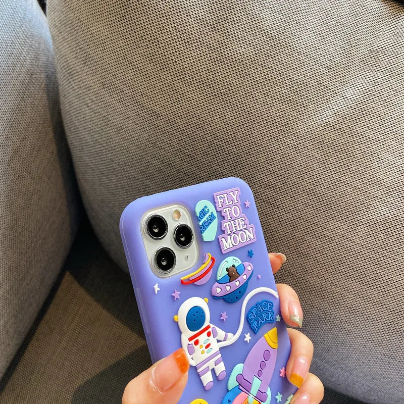 Purple silicone iPhone case with cartoon astronaut spaceman design showing precise port cut-outs