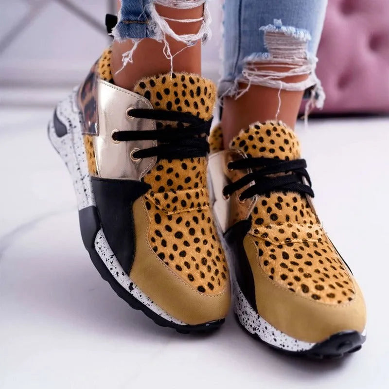 Women's suede sneakers with a wedge heel in various colours on a white background.