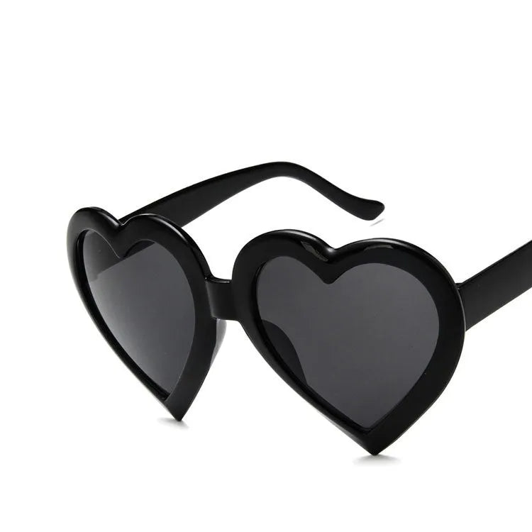 Children's heart-shaped sunglasses with bright red resin lenses and full rim frame