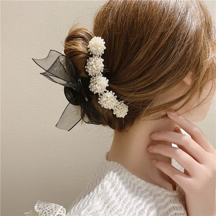 Korean pearl bow hair clip in black with alloy construction and manual bowknot design
