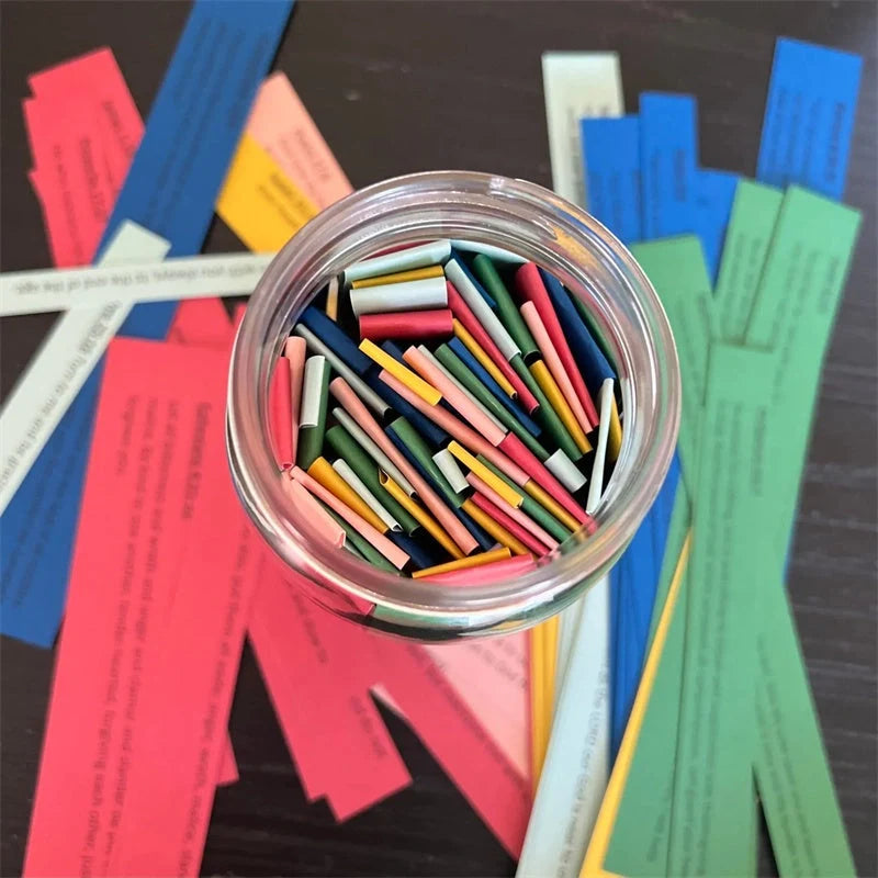 Handmade glass jar containing 67 color-coded Bible verses for emotional support