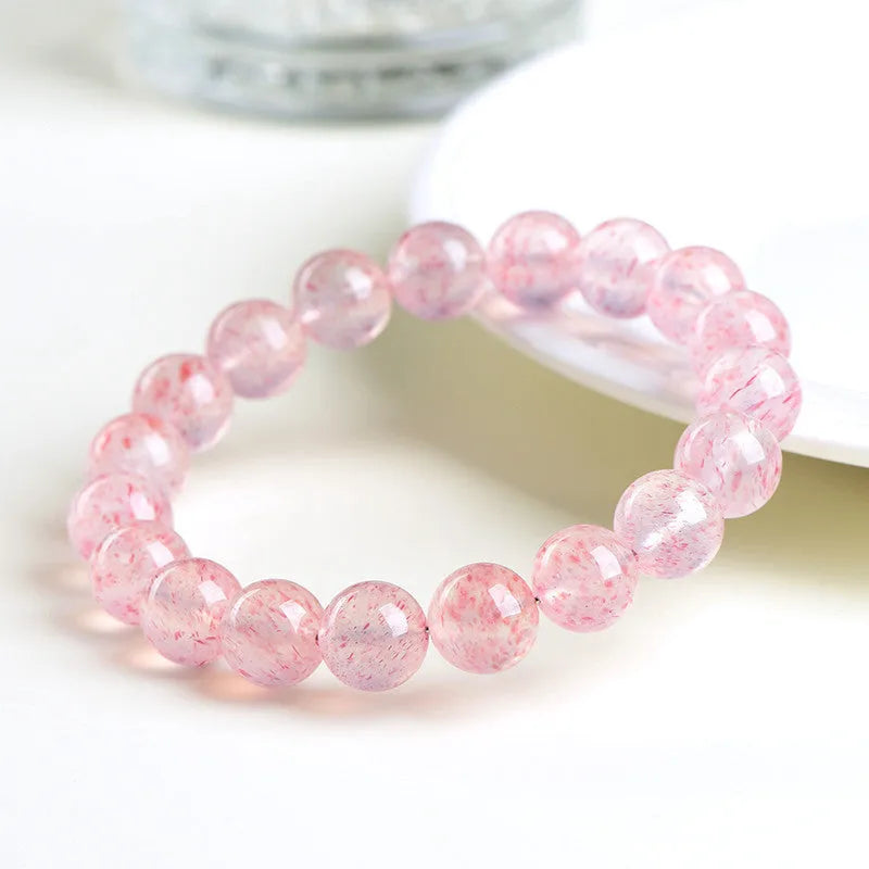 Natural strawberry quartz bracelet with white water crystal beads measuring 10-10.8mm