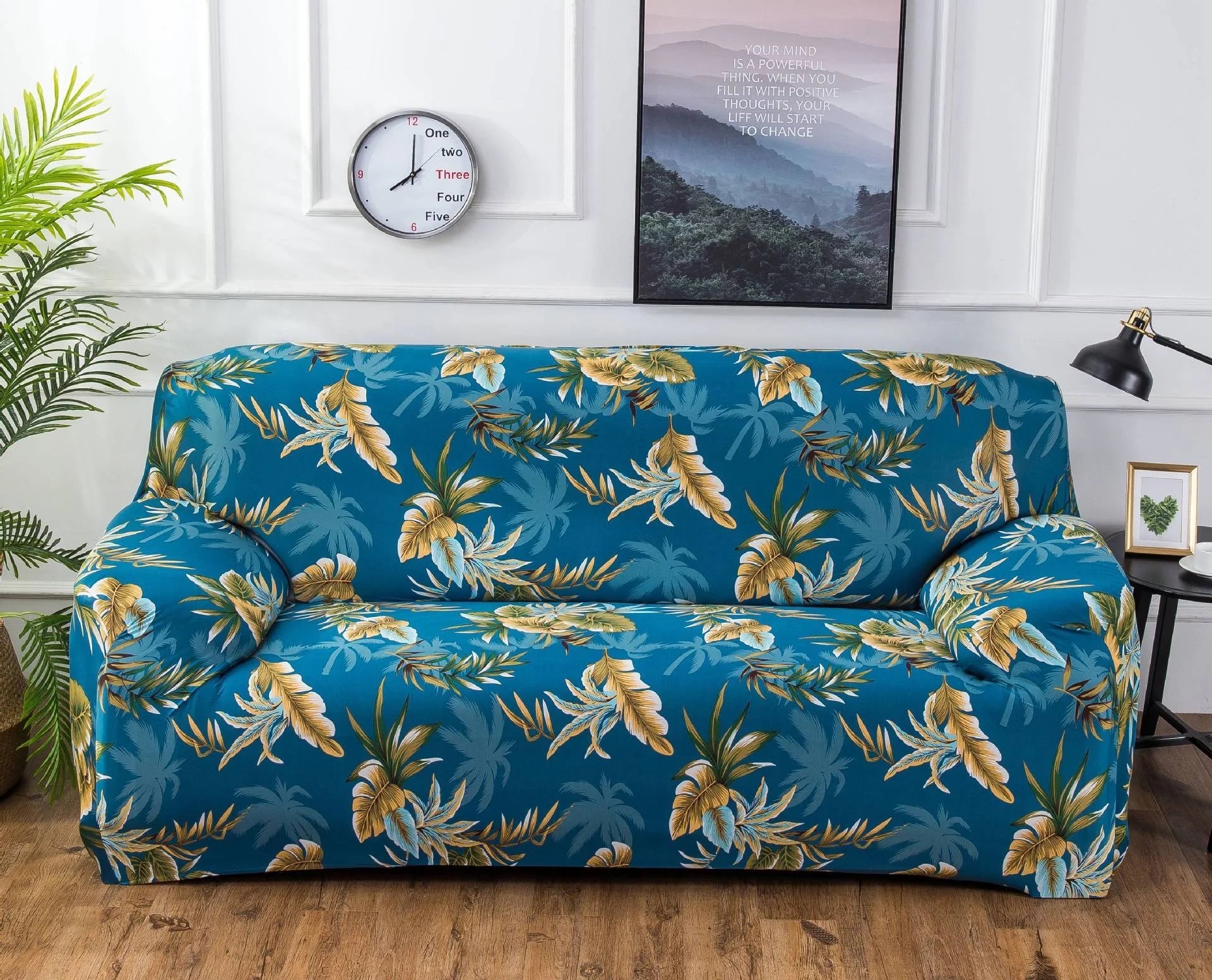 Printed stretchable sofa slipcover covering a three-seater sofa in a modern geometric pattern
