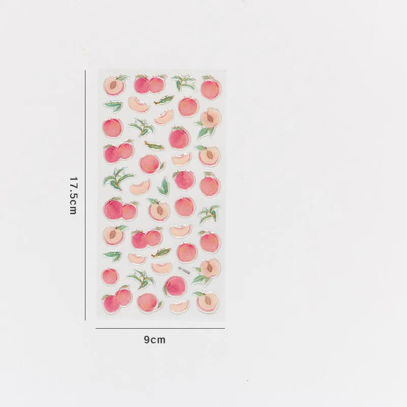 Roll of DIY fruit bronzing stickers showing grape, orange, passion fruit, peach, pineapple, and strawberry designs