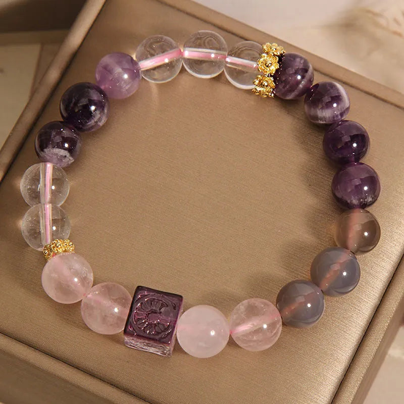 Close-up of a purple women's bracelet with 10mm amethyst crystal beads and rhinestone decoration on an adjustable strap.