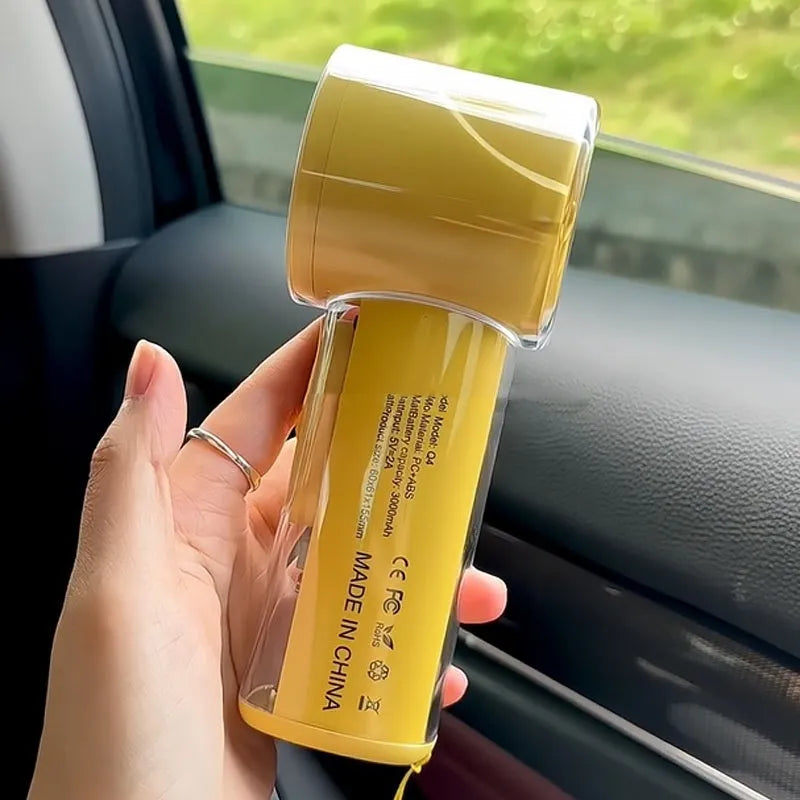 Small handheld fan with ice compress function in black, white, or yellow colours, showing portable size.