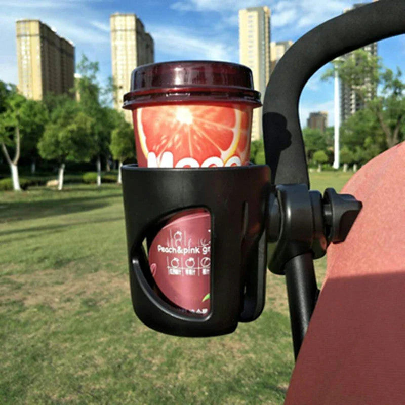 Universal baby stroller cup holder with phone pocket attached to a stroller