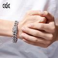 Men's Cuban chain bracelet with gold finish and geometric zircon pendant on a flat surface