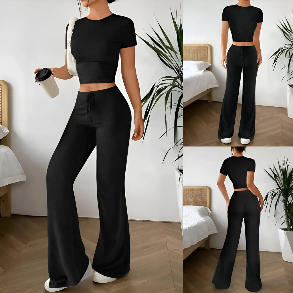 Black high-waist trousers and matching short-sleeve T-shirt co-ord set laid flat.