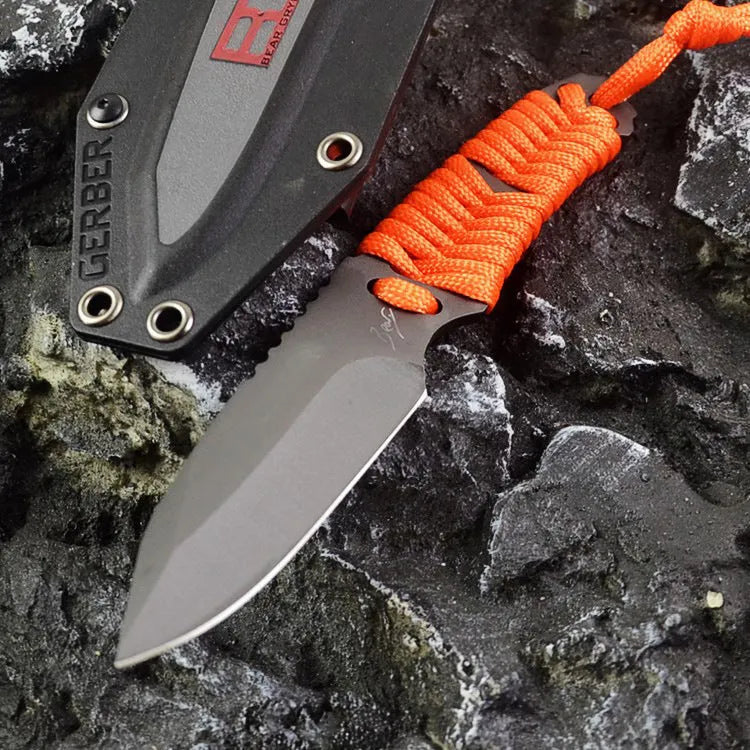 Straight survival knife with rope handle and black ABS sheath on a paper box.