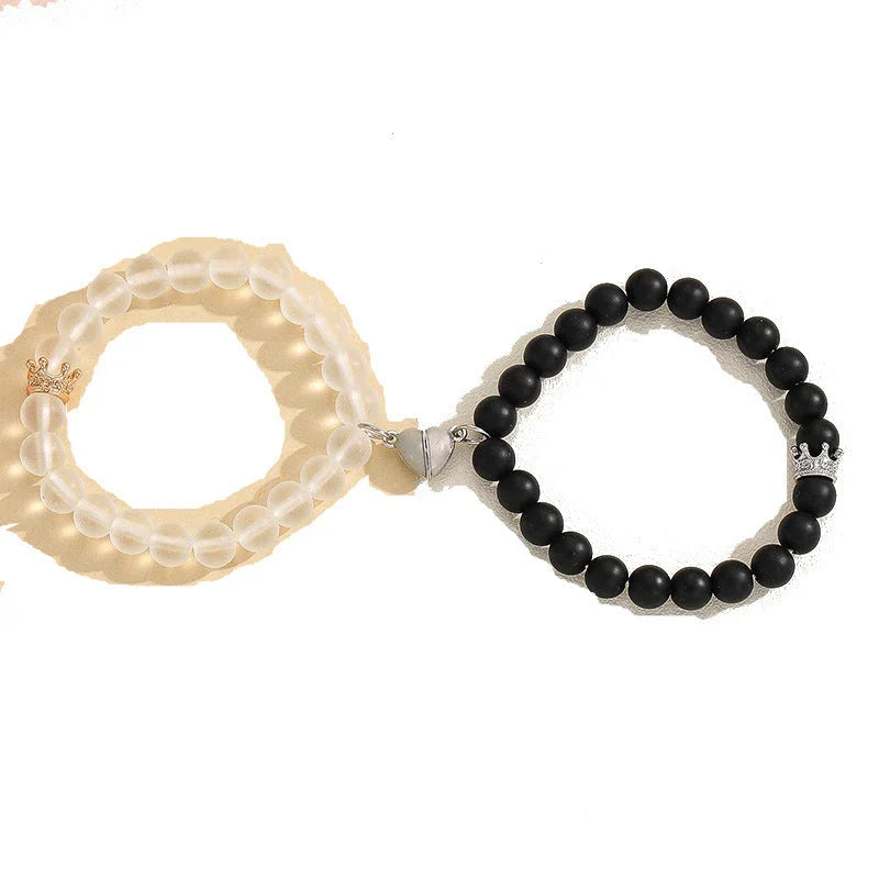 Luminous glow-in-the-dark crown bracelet set in white and black colors, showcasing a unique design and enchanting nighttime glow