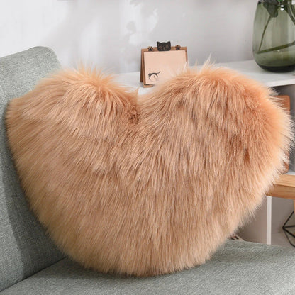 Plush heart-shaped throw pillows in various colors and styles for cozy sofa decor