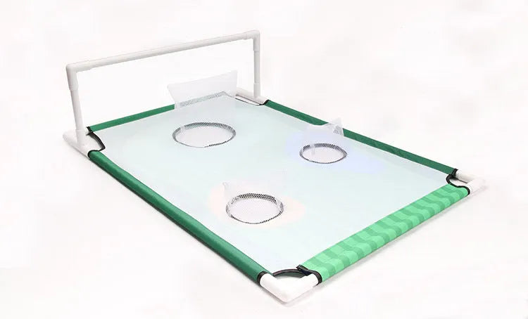 Green golf swing practice net with PVC frame and Oxford cloth target set up outdoors with balls and mat