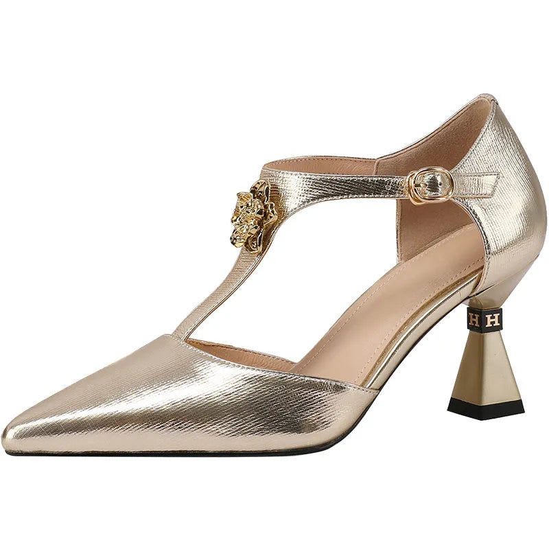 Gold women's pointed toe leather sandals with hollowed openwork design on upper.