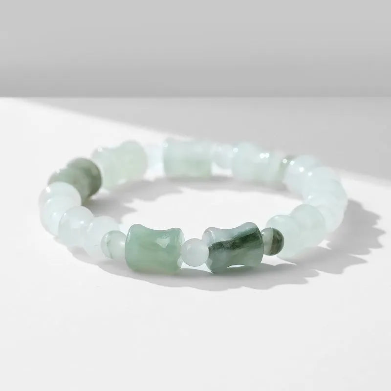 Tianshan Emerald and natural chalcedony diamond-cut beaded bracelet with coconut shell beads and a safety lock.
