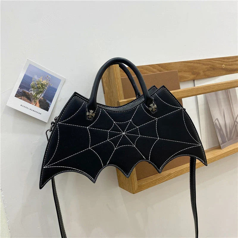 A stylish PU leather shoulder bag with a unique spider web and Batgirl-inspired design, available in a variety of vibrant colors.