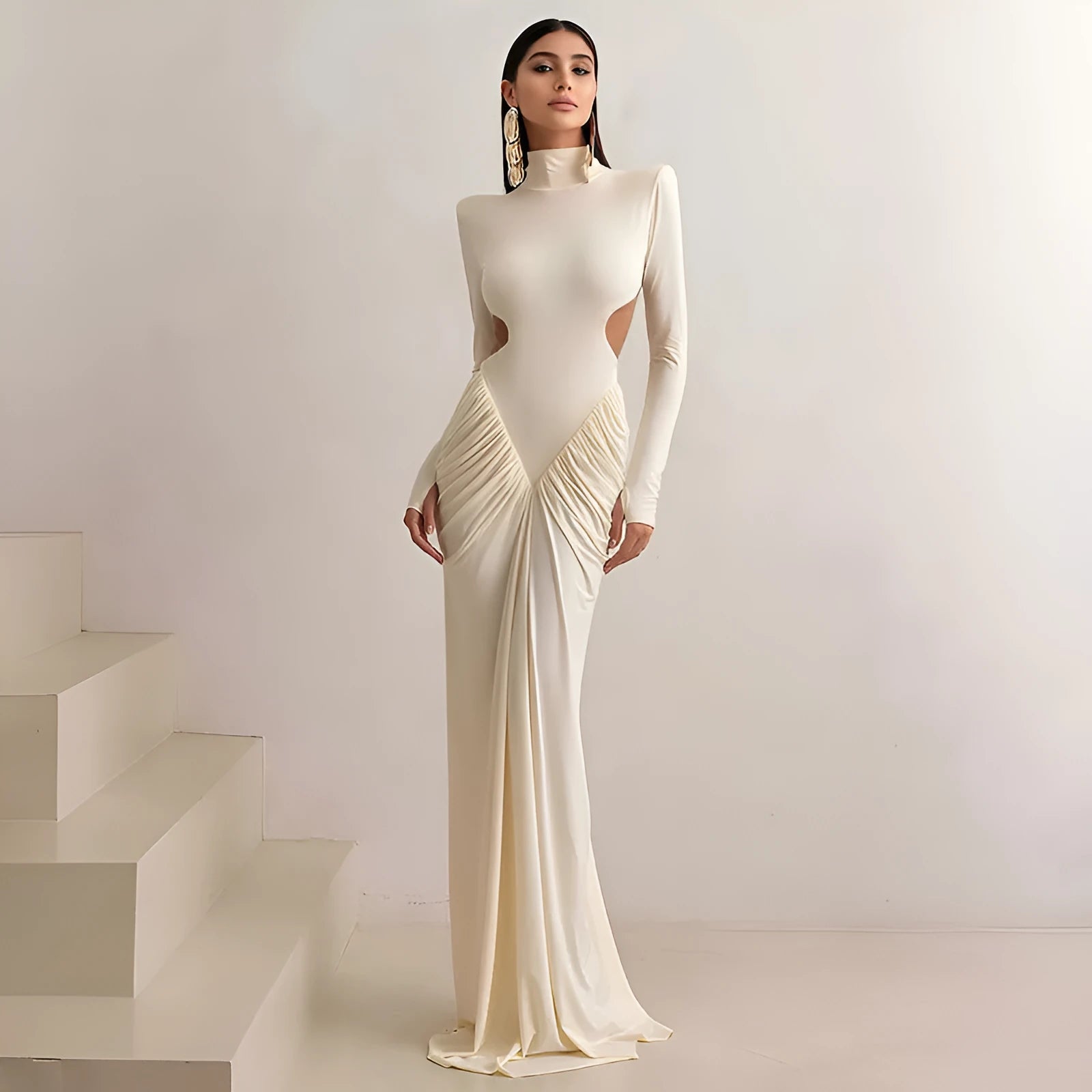 Women's light apricot high collar long sleeve pleated backless slim fit dress on a model.