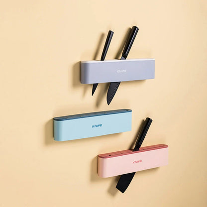 Wall-mounted kitchen knife holder in grey, pink, and light blue