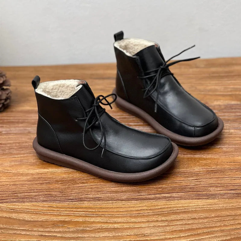 Women's black cowhide leather ankle boots with flat heel and round toe