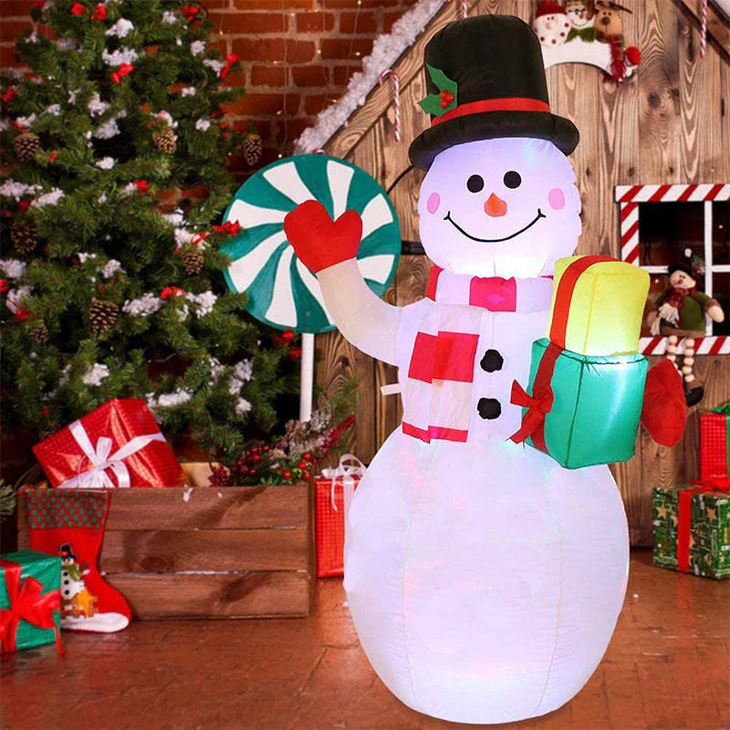 Illuminated Christmas inflatable decorations including Santa, snowman, and Christmas tree in a festive outdoor scene