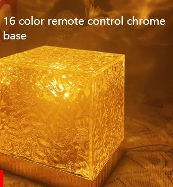 LED water ripple projection night light with remote control on wooden surface