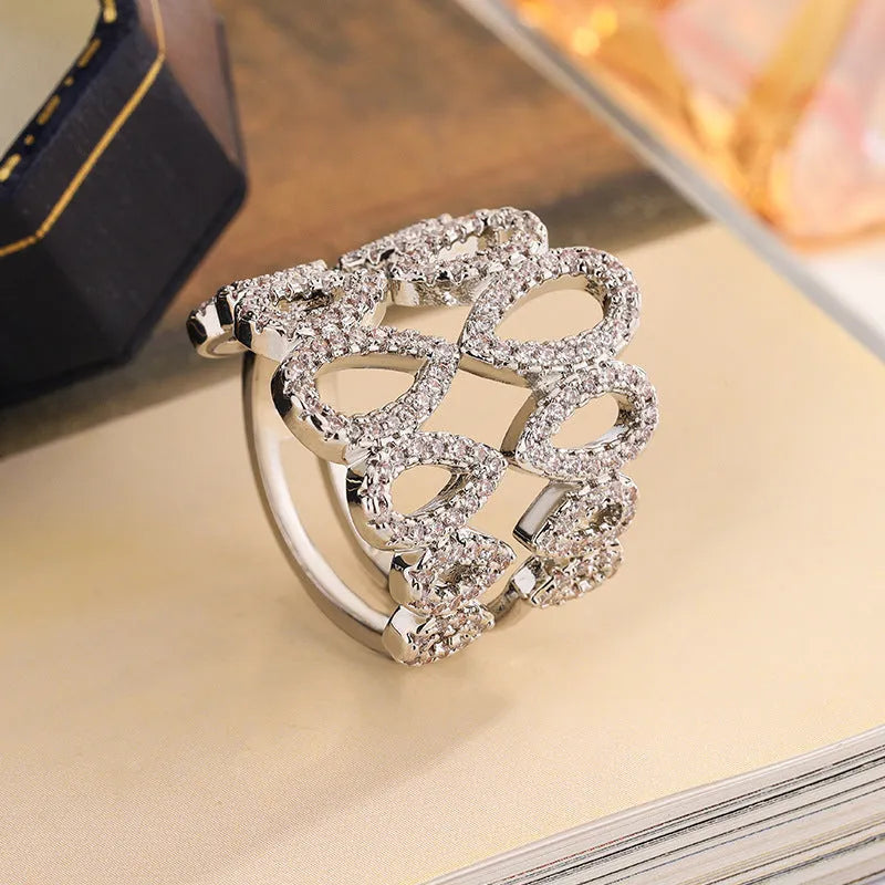 Women's gold plated copper ring with inlaid zircon stone and hexagon design on white background